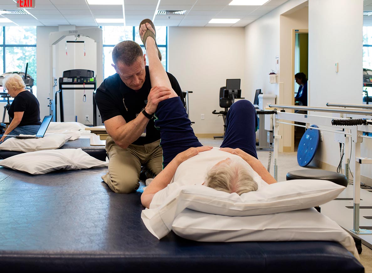 Physical therapist works with female patient on leg exercises at Cooley Dickinson Medical Group Orthopedics & Sports Medicine, West Hatfield, MA 01088.