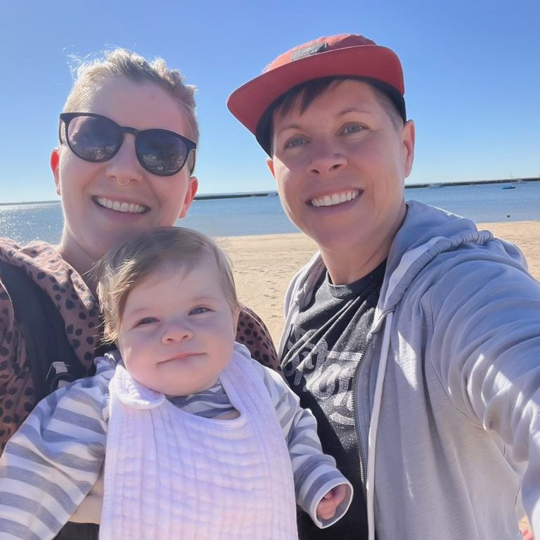 Family photo of Ashley, Jansyn, and Wilder at the beach