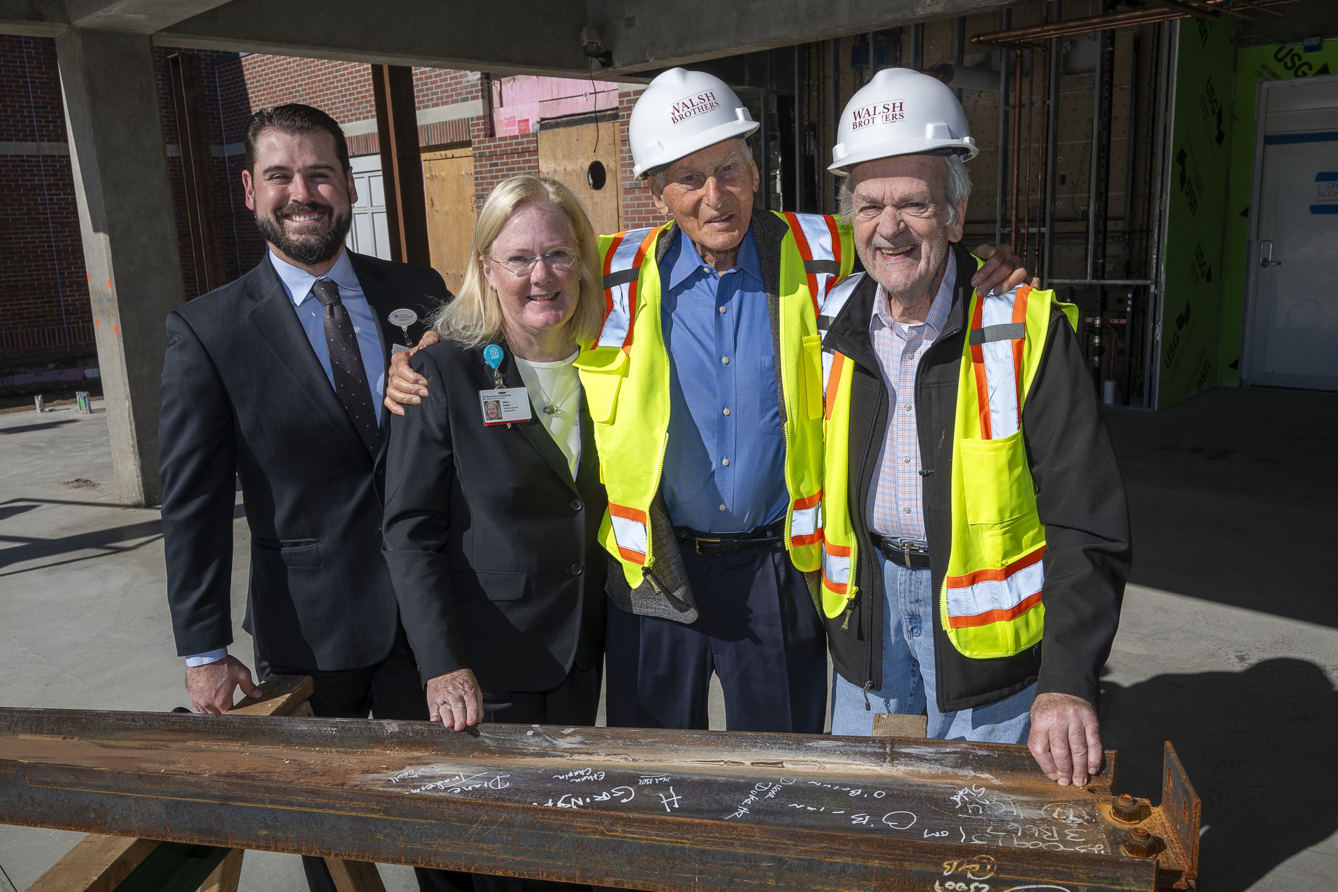 Four individuals at the ‘topping off’ ceremony held in front of the Cooley Dickinson Emergency Department