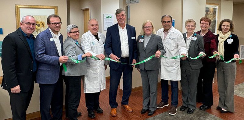 A group of people at a ribbon cutting ceremony