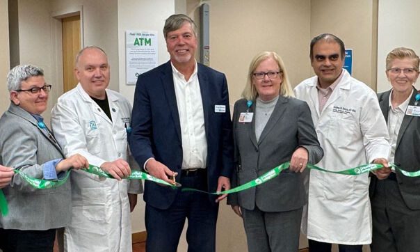 A group of people at a ribbon cutting ceremony